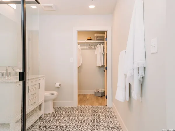 a bathroom with a toilet and a shower