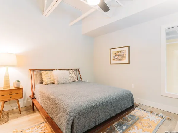 a bedroom with a bed and a night stand