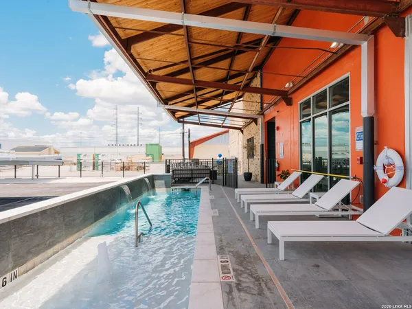 a view of a patio with a table and chairs