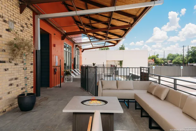 a view of a patio with couches and potted plants