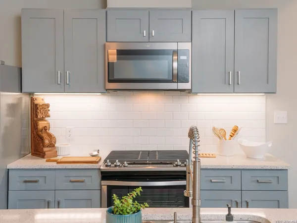 a kitchen with a stove and microwave