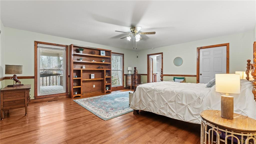 8315 Nicholson Road Cumming, GA 30028 - Photo 15 of 62 a spacious bedroom with a bed and wooden floor