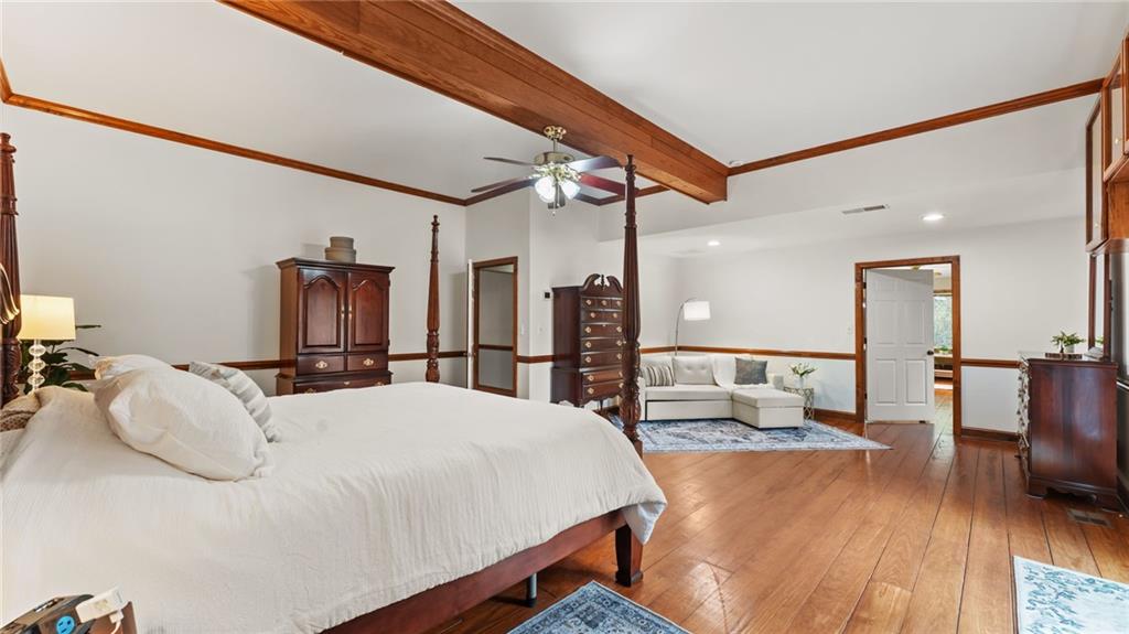 8315 Nicholson Road Cumming, GA 30028 - Photo 20 of 62 a large bedroom with bed and a table