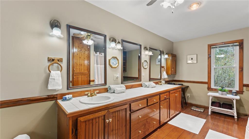8315 Nicholson Road Cumming, GA 30028 - Photo 24 of 62 a bathroom with a sink double vanity and a mirror