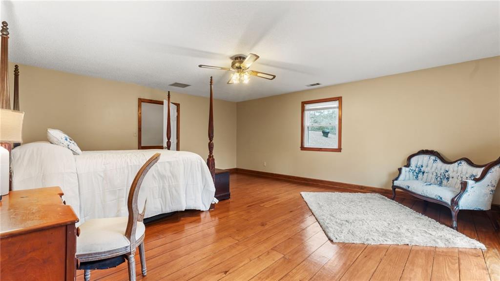 8315 Nicholson Road Cumming, GA 30028 - Photo 34 of 62 a bedroom with a bed and wooden floor