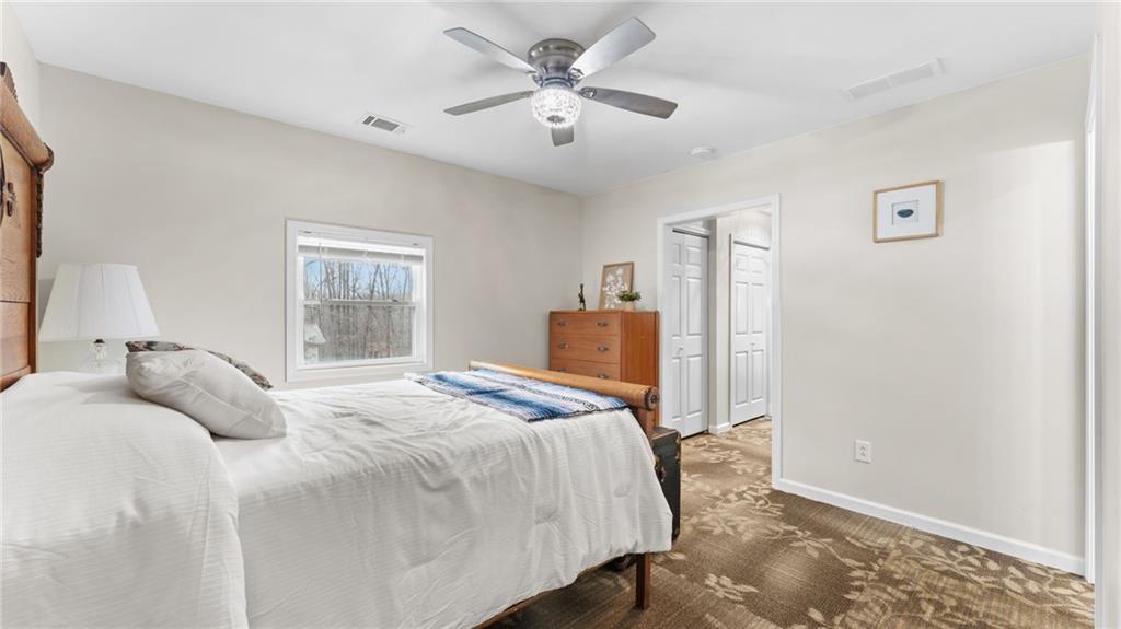 8315 Nicholson Road Cumming, GA 30028 - Photo 39 of 62 a bedroom with a bed and a chandelier