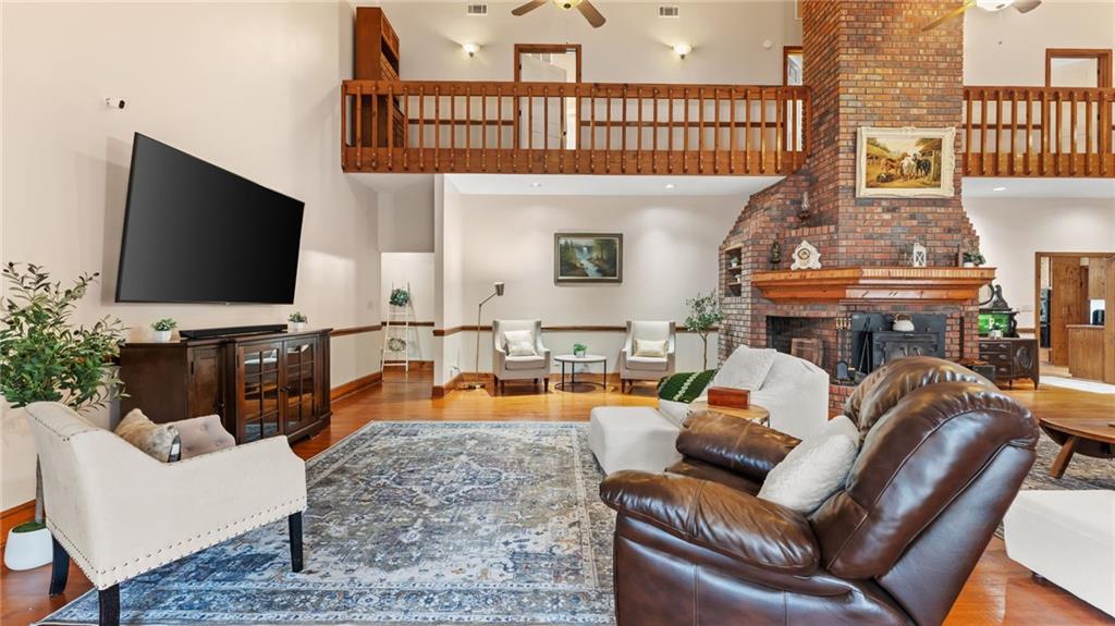 8315 Nicholson Road Cumming, GA 30028 - Photo 5 of 62 a living room with furniture a flat screen tv and a floor to ceiling window