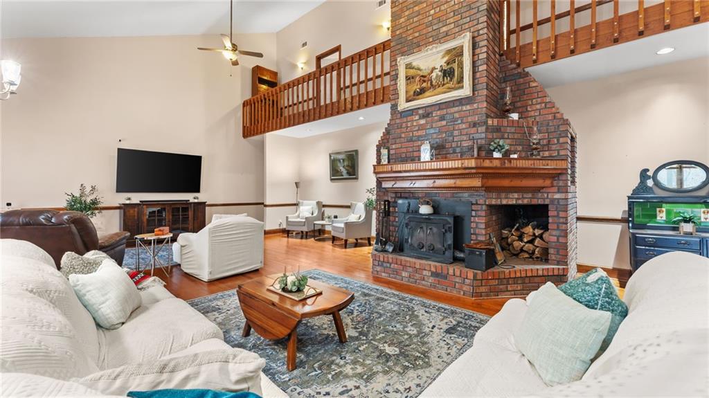 8315 Nicholson Road Cumming, GA 30028 - Photo 7 of 62 a living room with furniture a fireplace and a flat screen tv