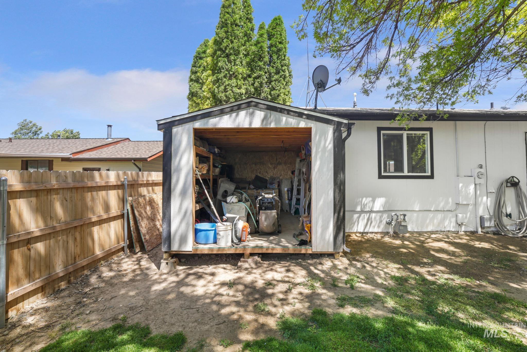 712 Locust Street Kimberly, ID 83341 - Photo 21 of 26 Carpeted room featuring a ceiling fan, light gray painted walls, and a built-in closet with shelving and hanging rods