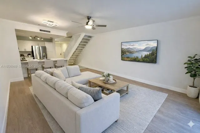 a living room with furniture and wooden floor
