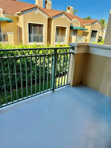 a view of a brick house with large windows