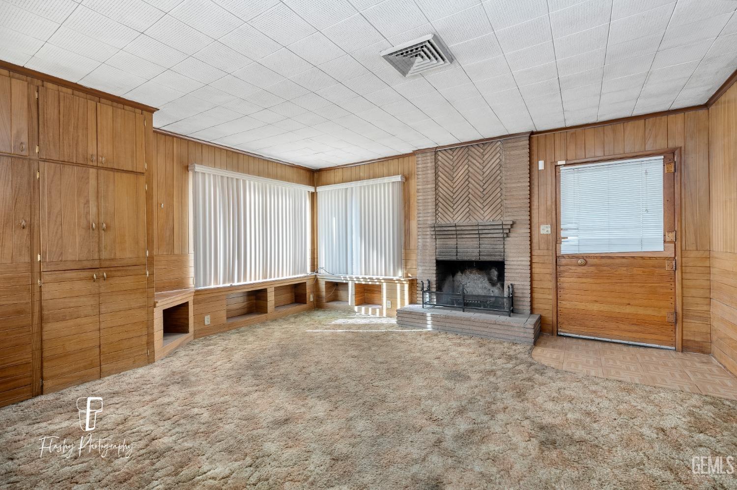 Undisclosed Address Bakersfield, CA 93304 - Photo 13 of 38 a view of an empty room with a fireplace