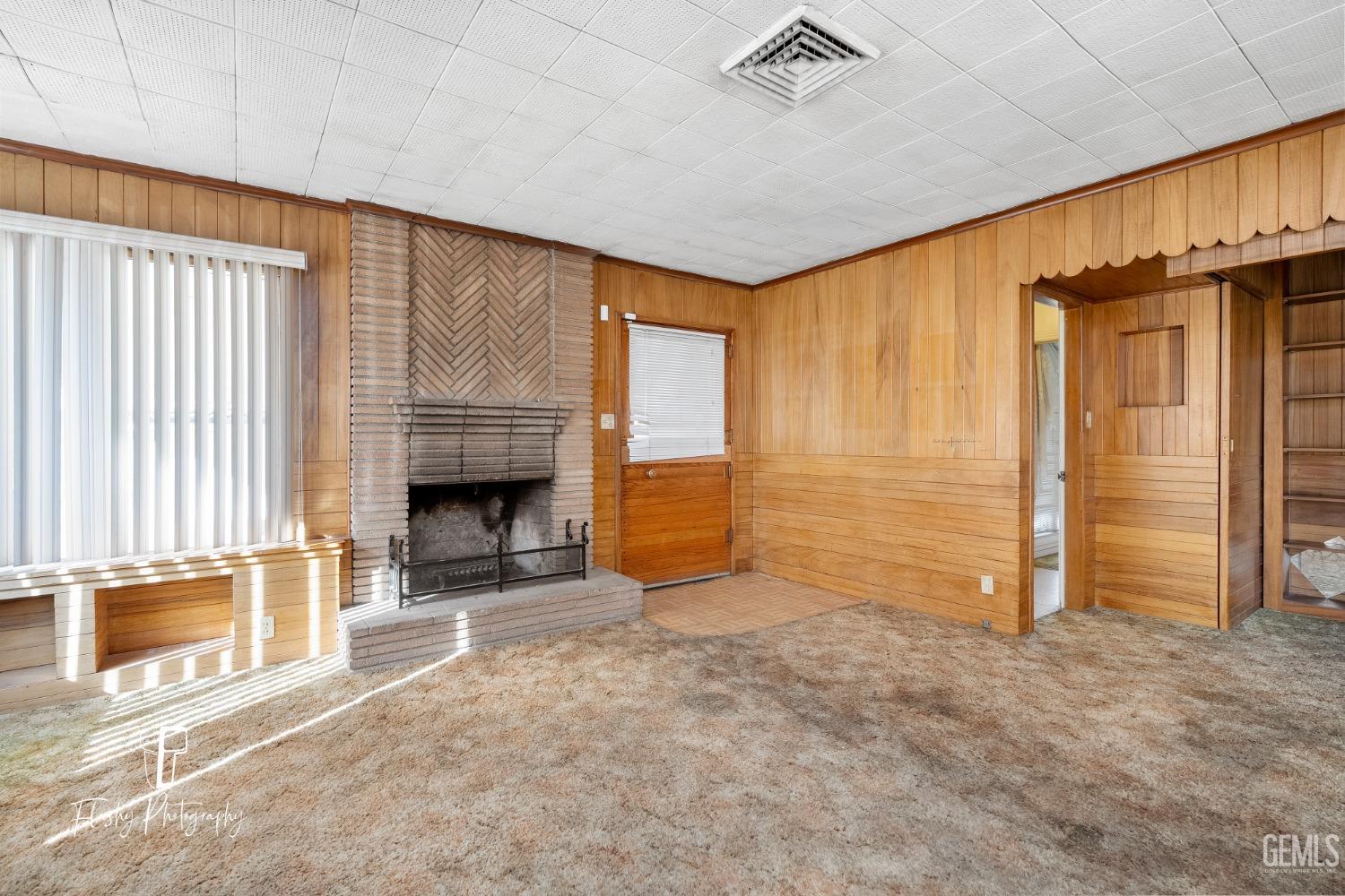 Undisclosed Address Bakersfield, CA 93304 - Photo 16 of 38 an empty room with a fireplace