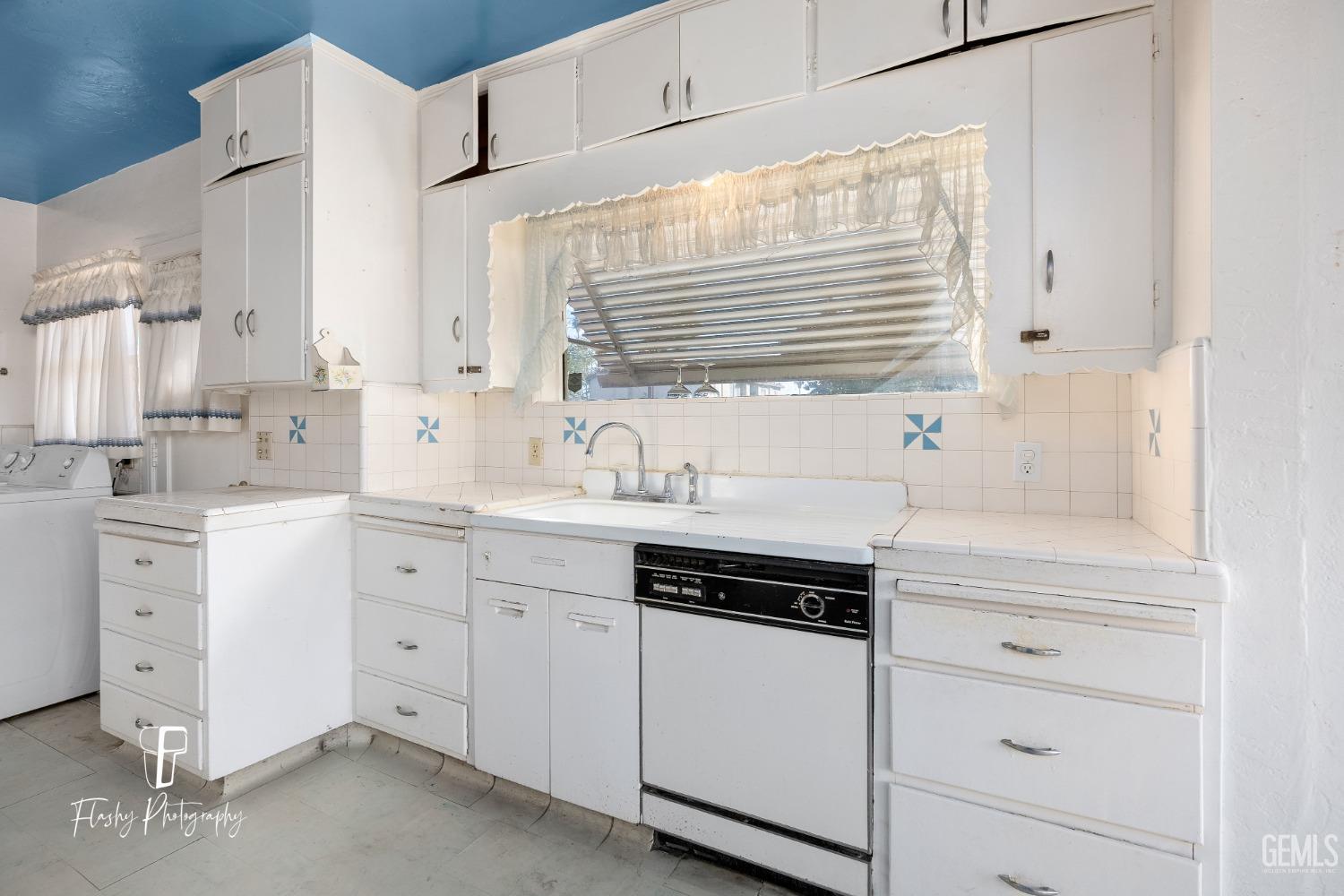 Undisclosed Address Bakersfield, CA 93304 - Photo 17 of 38 a kitchen with white cabinets and white appliances