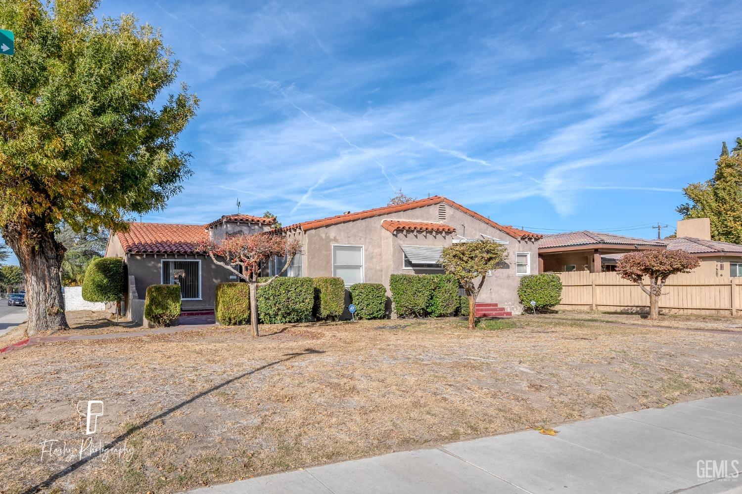 Undisclosed Address Bakersfield, CA 93304 - Photo 2 of 38 a front view of a building with a yard