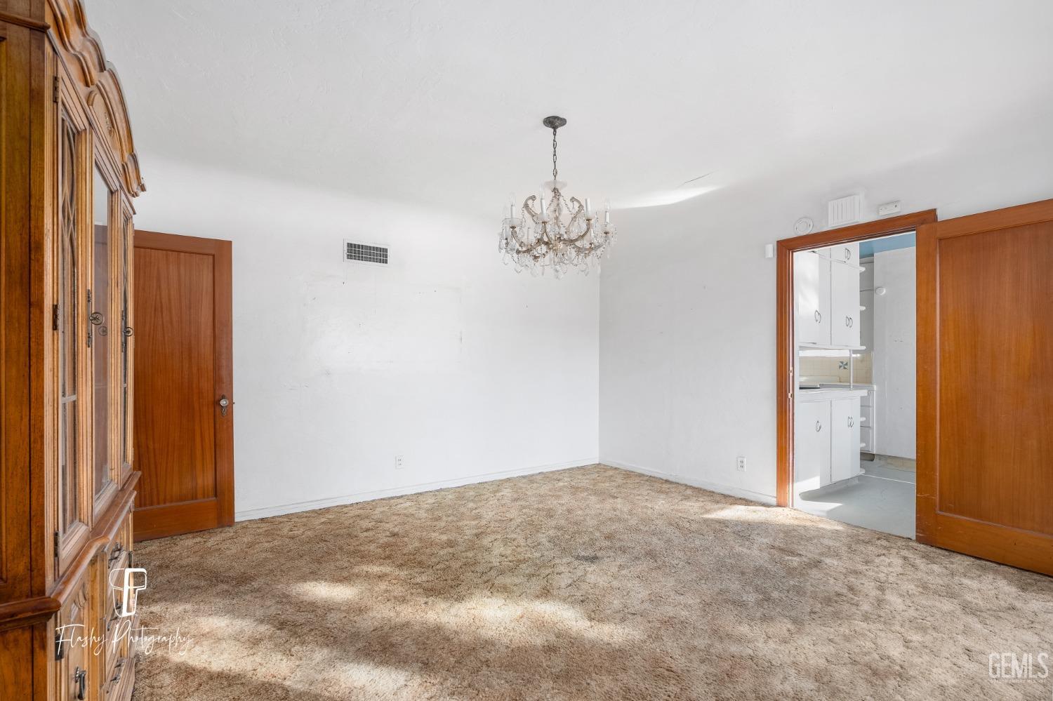 Undisclosed Address Bakersfield, CA 93304 - Photo 22 of 38 a view of a livingroom with a chandelier fan and closet