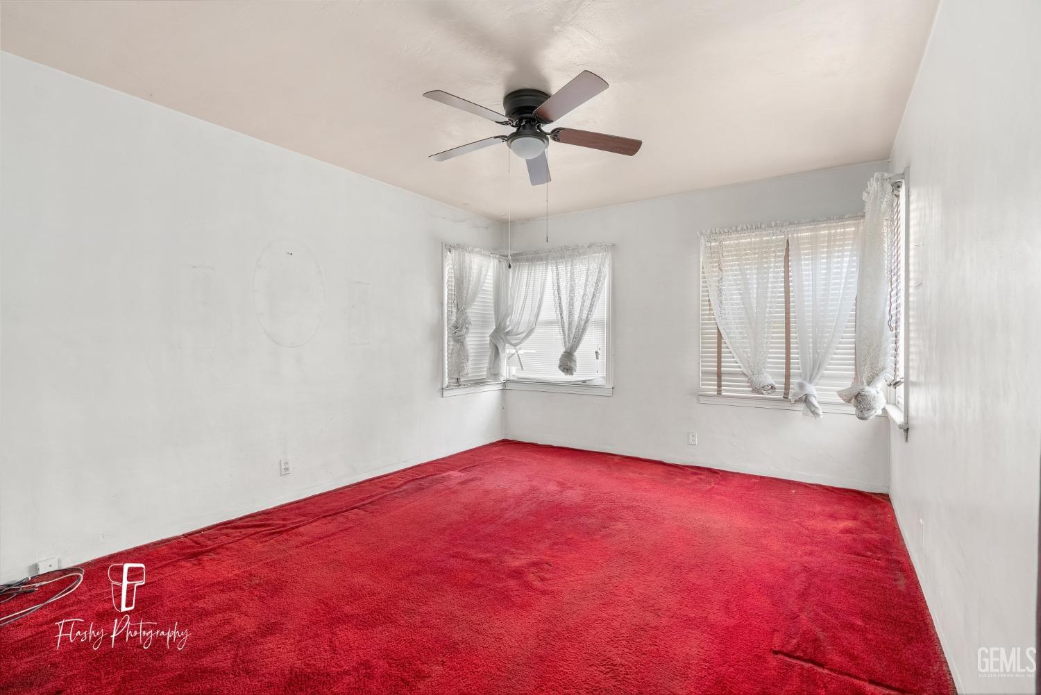 Undisclosed Address Bakersfield, CA 93304 - Photo 27 of 38 wooden floor in an empty room with a window