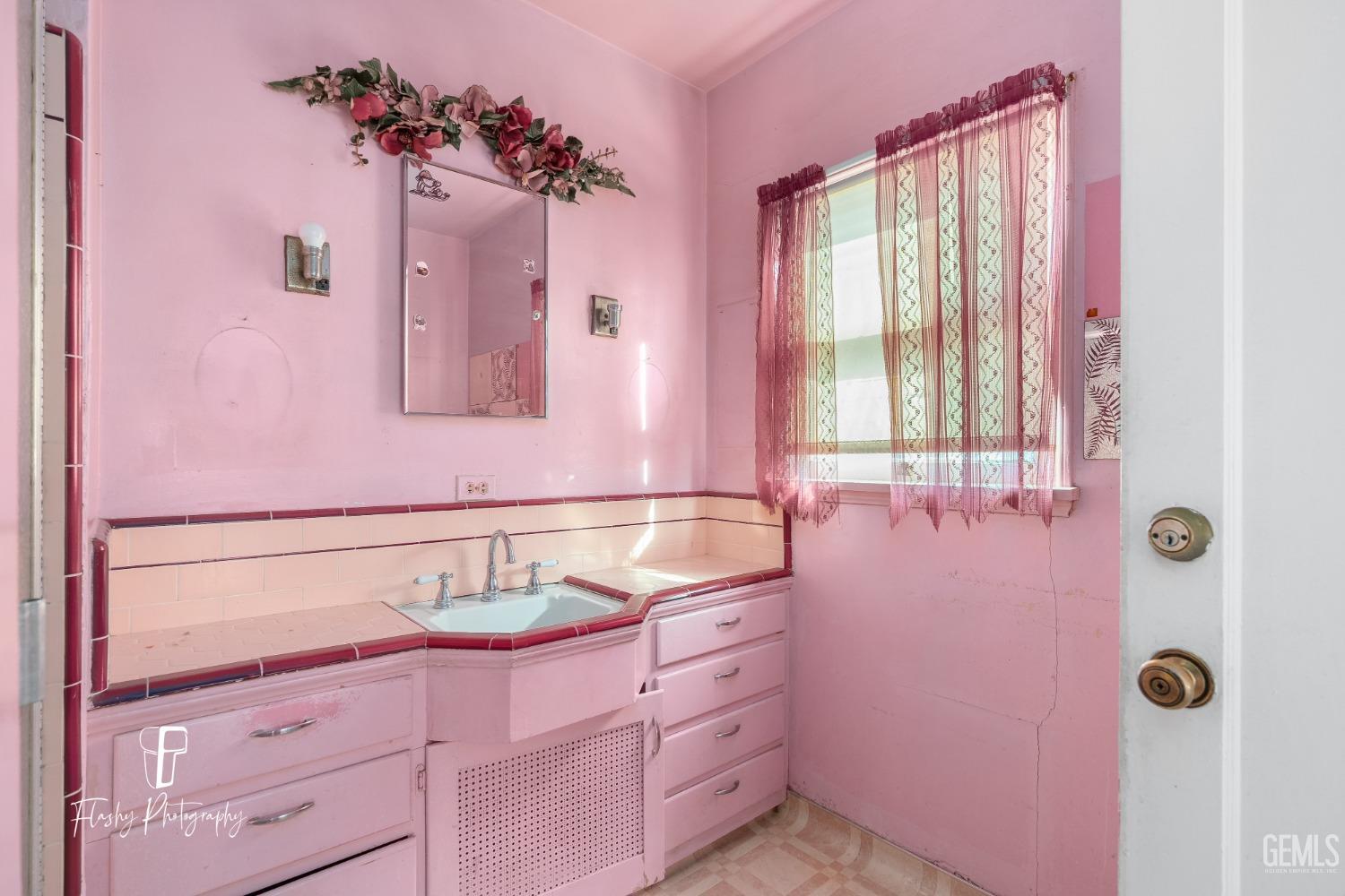 Undisclosed Address Bakersfield, CA 93304 - Photo 32 of 38 a bathroom with a sink and a mirror