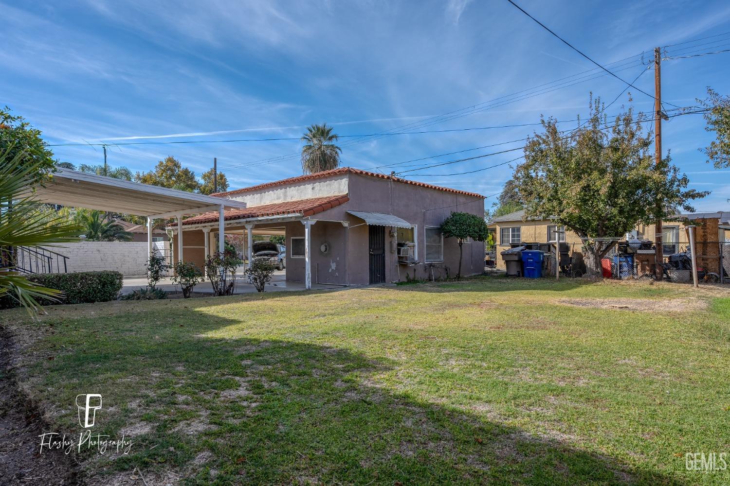 Undisclosed Address Bakersfield, CA 93304 - Photo 35 of 38 a front view of a house with a garden and porch