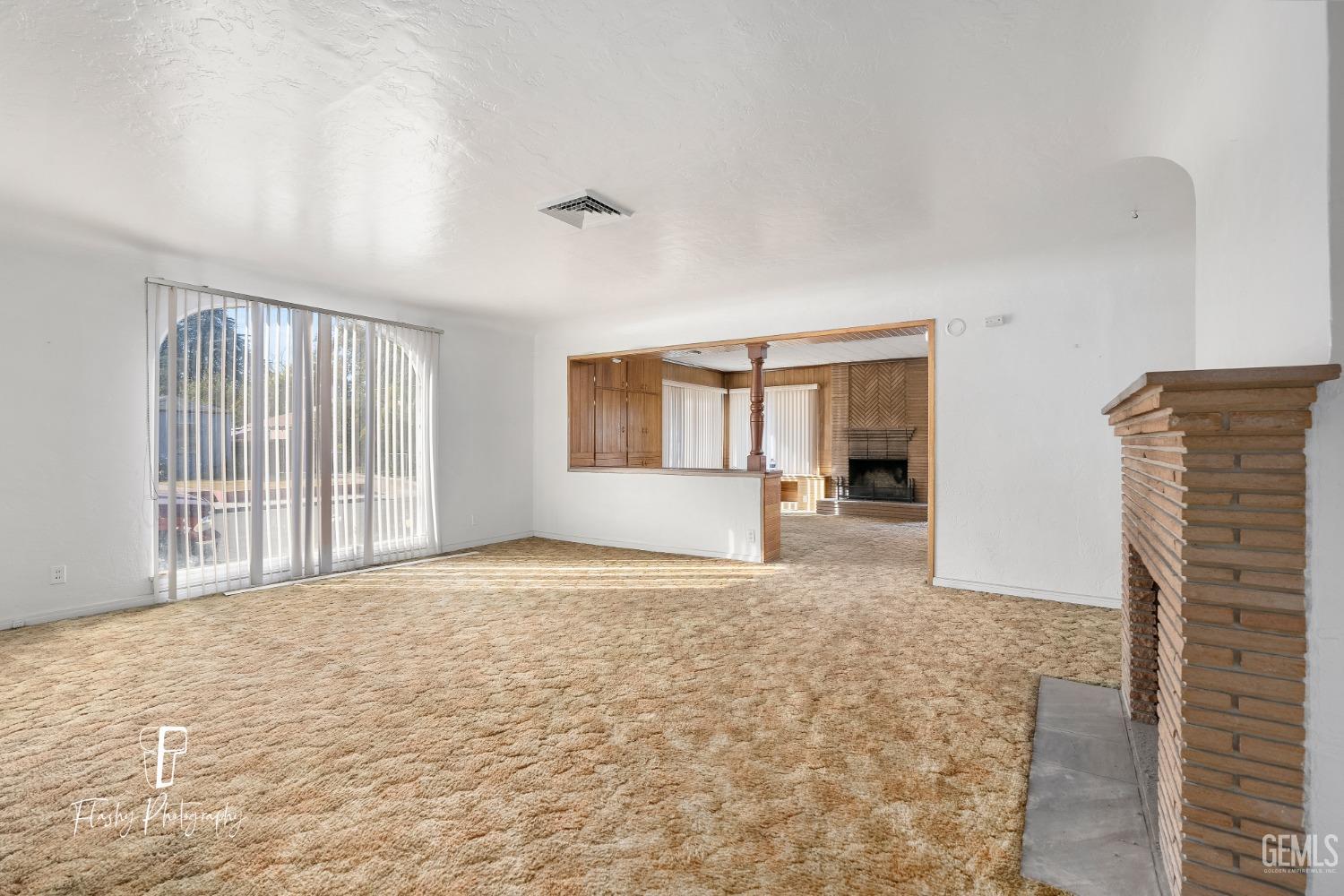 Undisclosed Address Bakersfield, CA 93304 - Photo 9 of 38 a view of an empty room with window and wooden floor