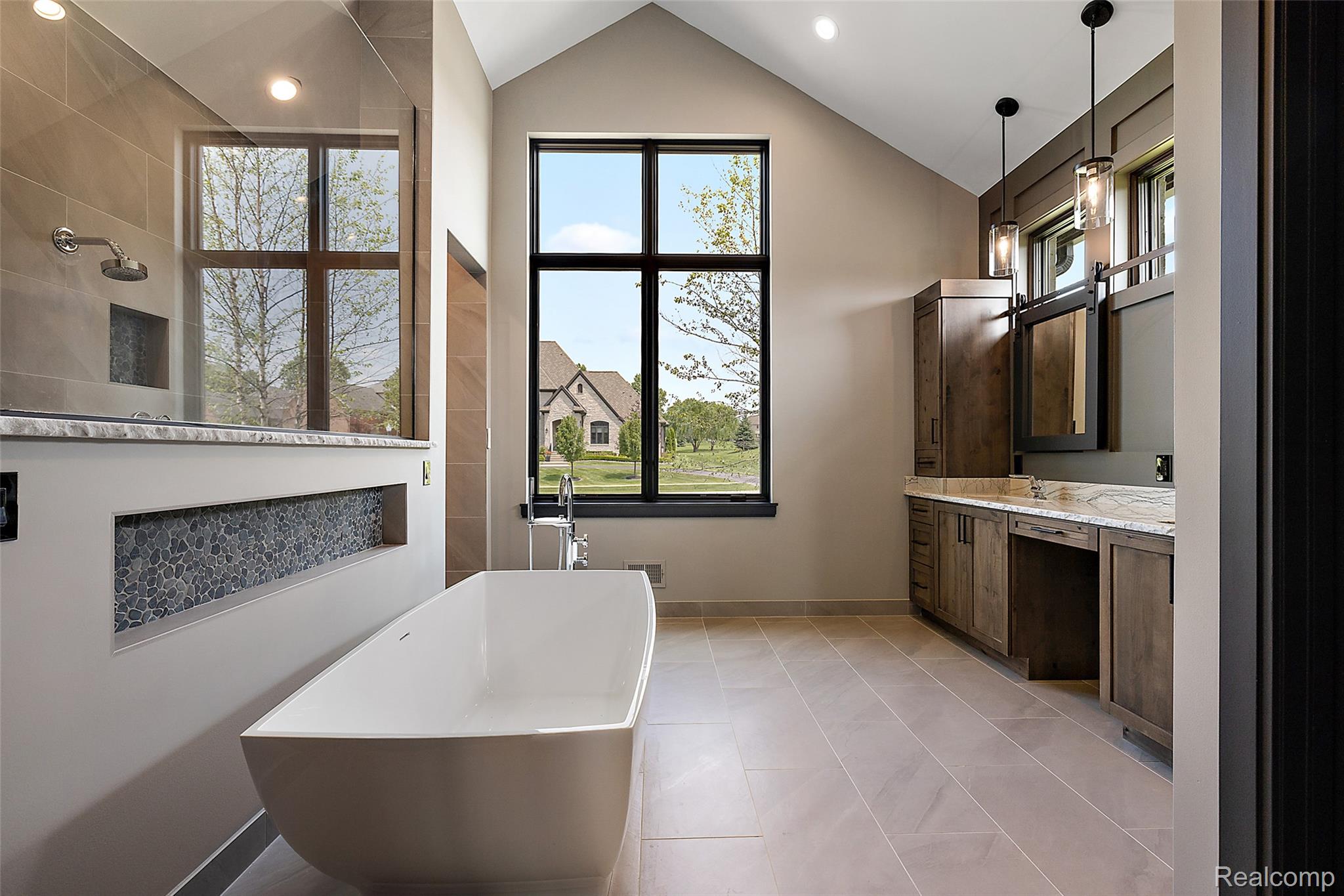 5541 Bordman Road Dryden, MI 48428 - Photo 13 of 27 Full bathroom featuring double vanity, a soaking tub, vaulted ceiling, light tile patterned flooring, and a walk in shower