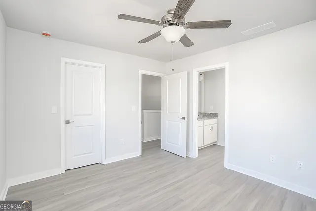 a view of an empty room with wooden floor