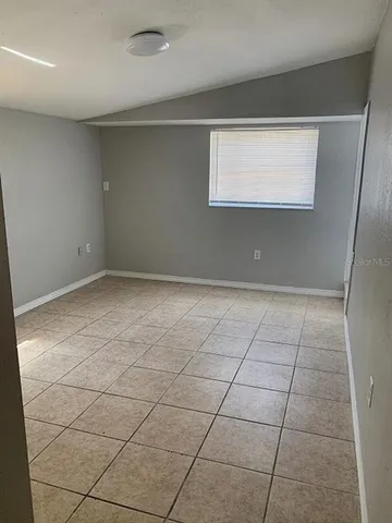 a view of an empty room with a window