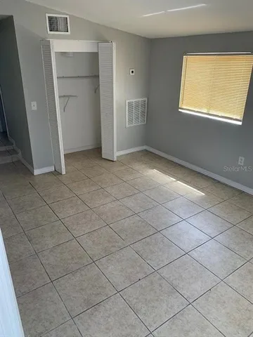 a view of an empty room and a window