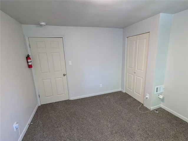 an empty room with closet area
