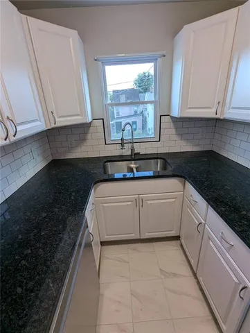 a kitchen with a sink and cabinets
