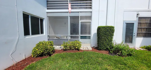 a view of a backyard with potted plants