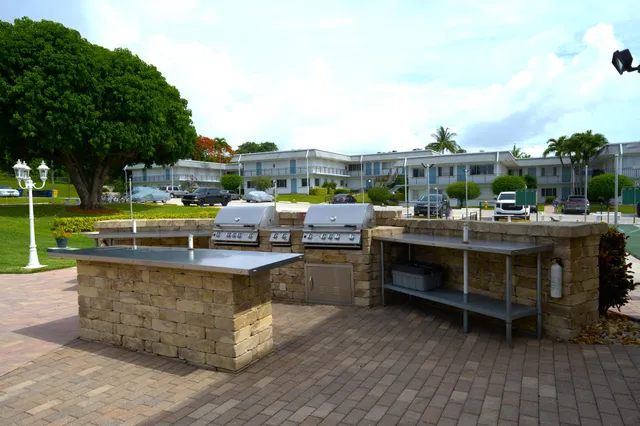 a view of a swimming pool with outdoor seating and plants