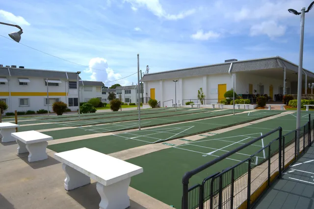 a front view of a house with a garden and patio