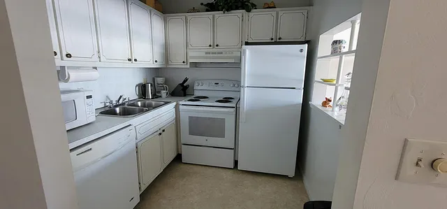 a white refrigerator freezer sitting in a kitchen