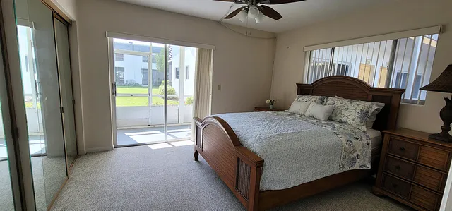 a spacious bedroom with a bed and a dresser