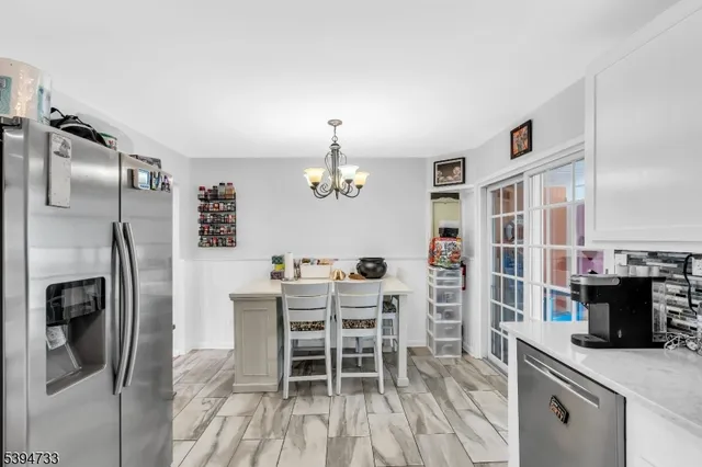 a kitchen with stainless steel appliances a refrigerator and a stove top oven