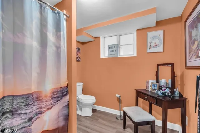 a bathroom with a toilet a sink and a mirror