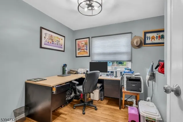 a view of a workspace with furniture and a window