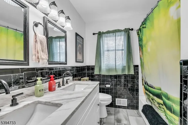 a bathroom with a sink a toilet and mirror