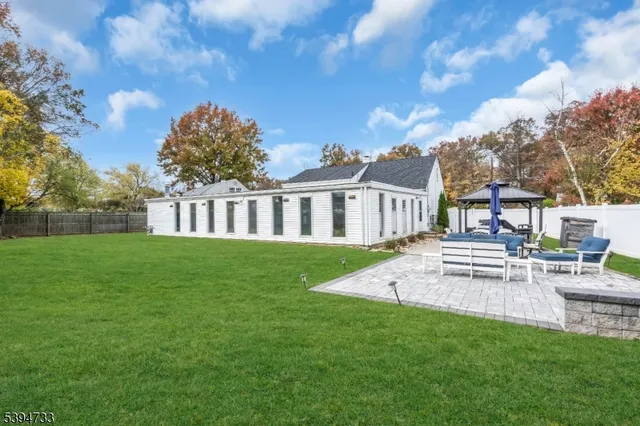 a view of a house with backyard and sitting area