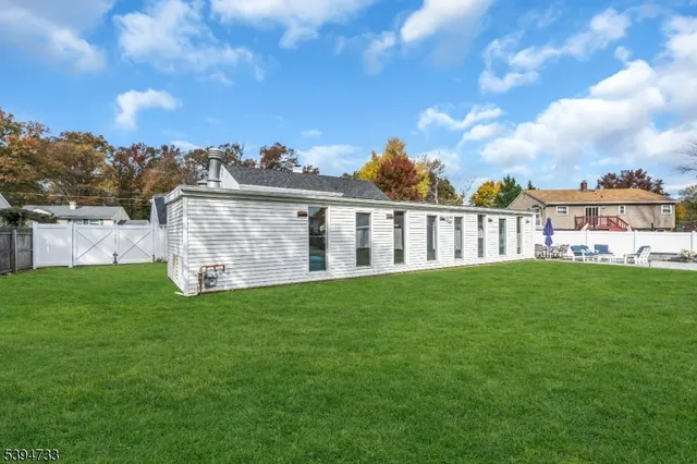 a view of a house with a backyard