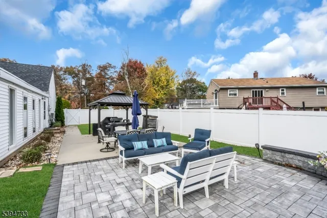 a view of a patio with couches and table and chairs and potted plants