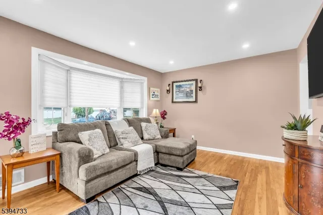 a living room with furniture and flowers