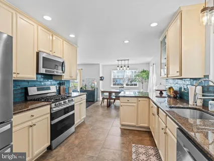 a kitchen with a sink stove and microwave