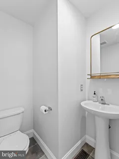 a bathroom with a sink mirror and toilet