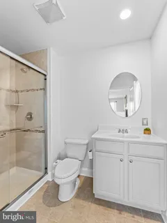 a bathroom with a toilet a sink and a mirror
