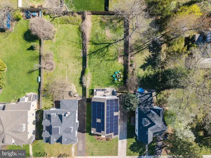 an aerial view of residential houses with outdoor space and parking