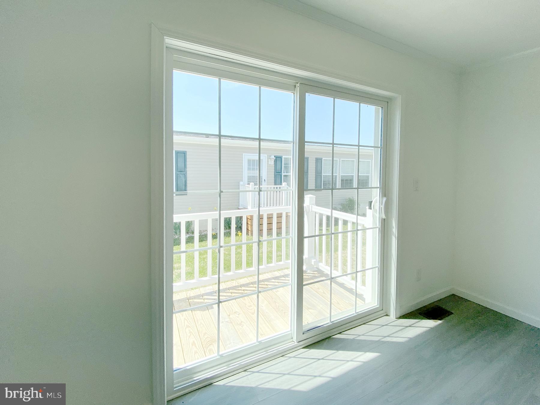 12 Carlisle Way Lewes, DE 19958 - Photo 13 of 25 Bright and airy indoor-outdoor view.