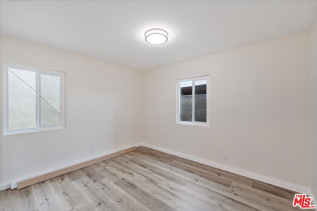 8605 Penny Drive Riverside, CA 92503 - Photo 17 of 22 an empty room with wooden floor and windows