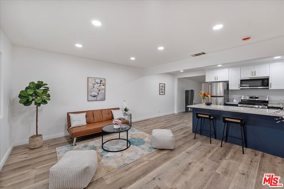 8605 Penny Drive Riverside, CA 92503 - Photo 10 of 22 a living room with furniture kitchen view and a potted plant
